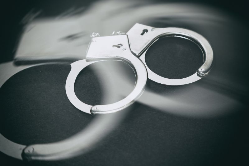 a pair of handcuffs on a dark background