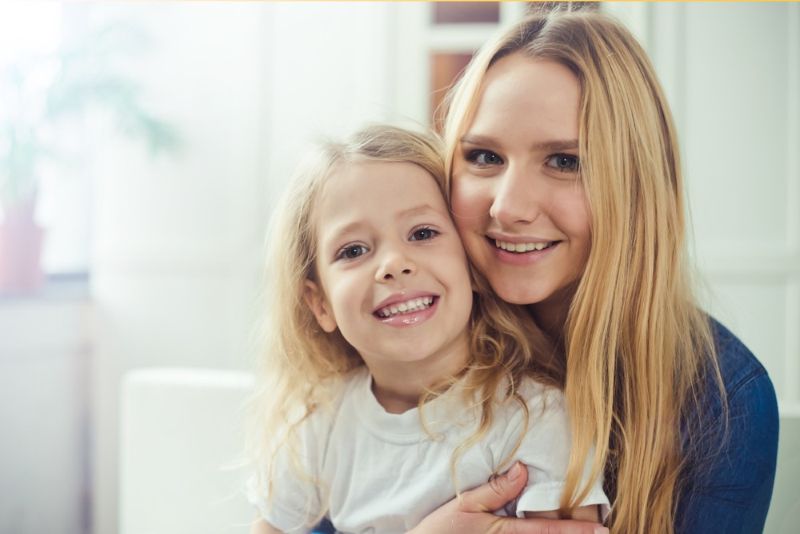 a young mother hugging her daughter