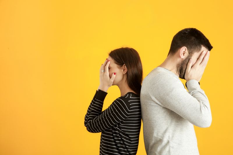 upset couple with their faces in their hands
