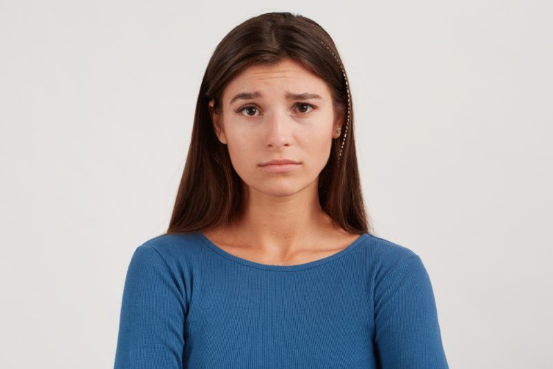 young woman looking worried and confused