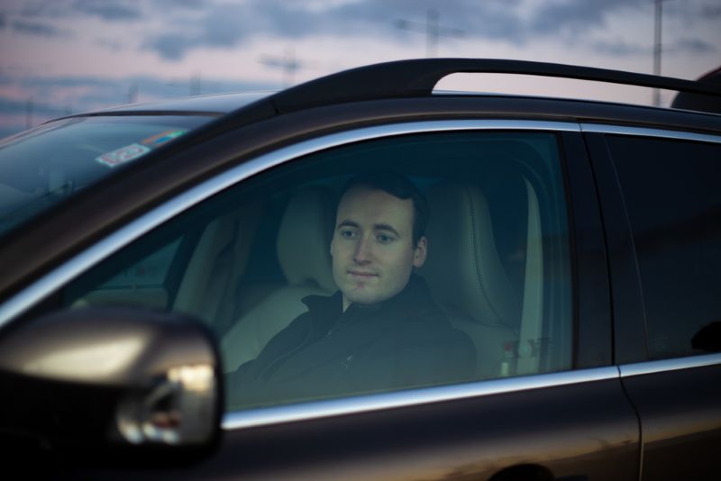 Man making a turn in his car driving during twilight