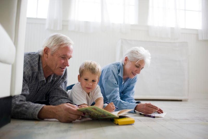 Grandparents playing on the floor with grandchild